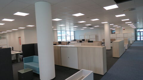 Offenes Büro Campus Mühlheim Blick in ein Offenens Büro am Campus Mühlheim, helle Holzmöbel, blauer Sessel, zwei weiße Säulen